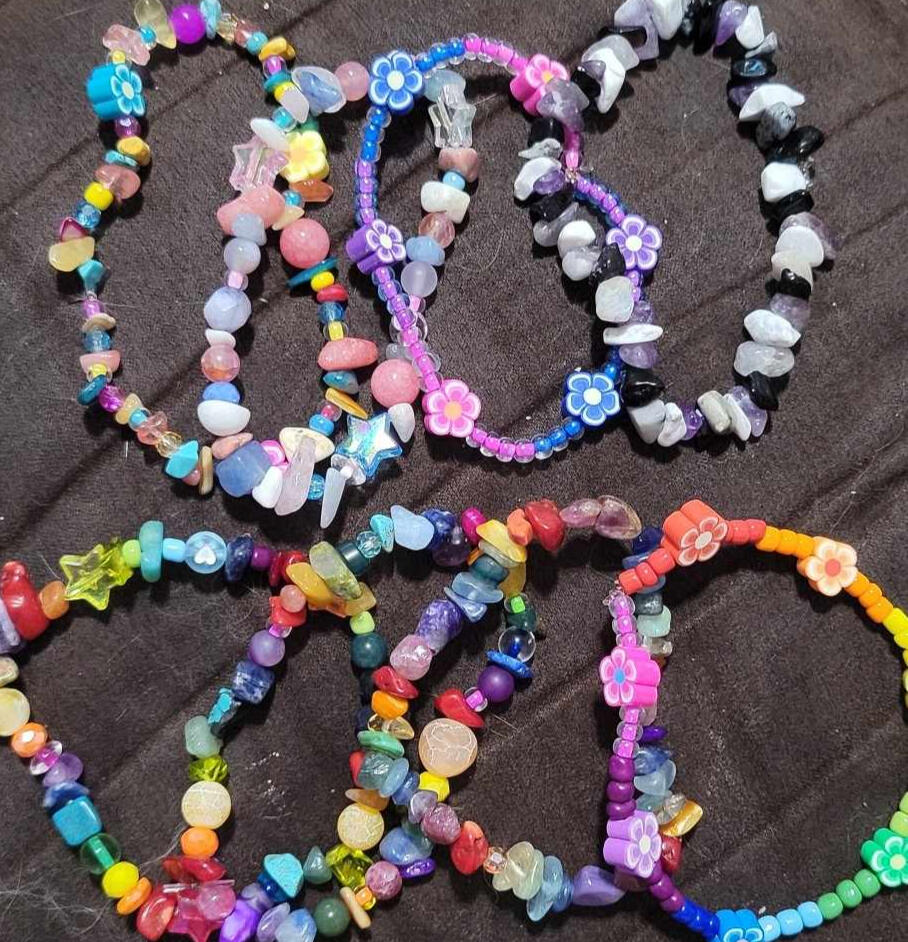 a picture of some pride flag bracelets by robi