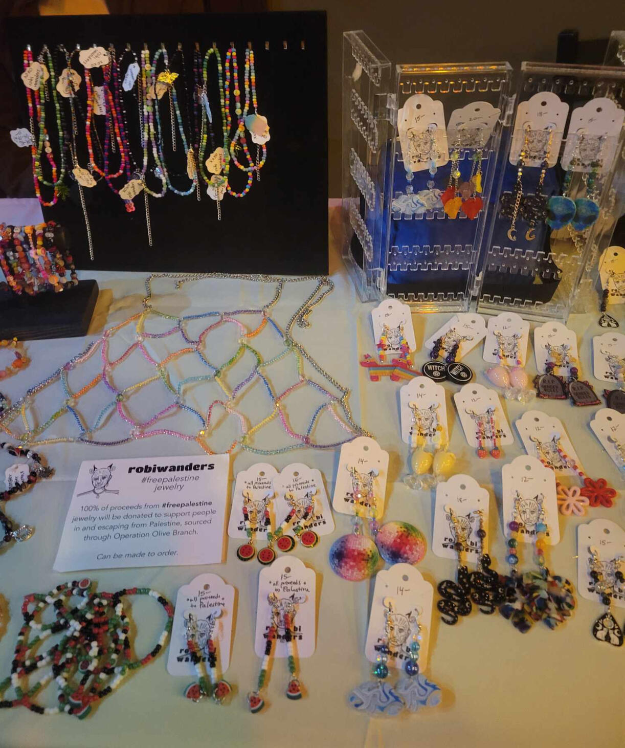 a table spread with robiwanders bracelets and chokers