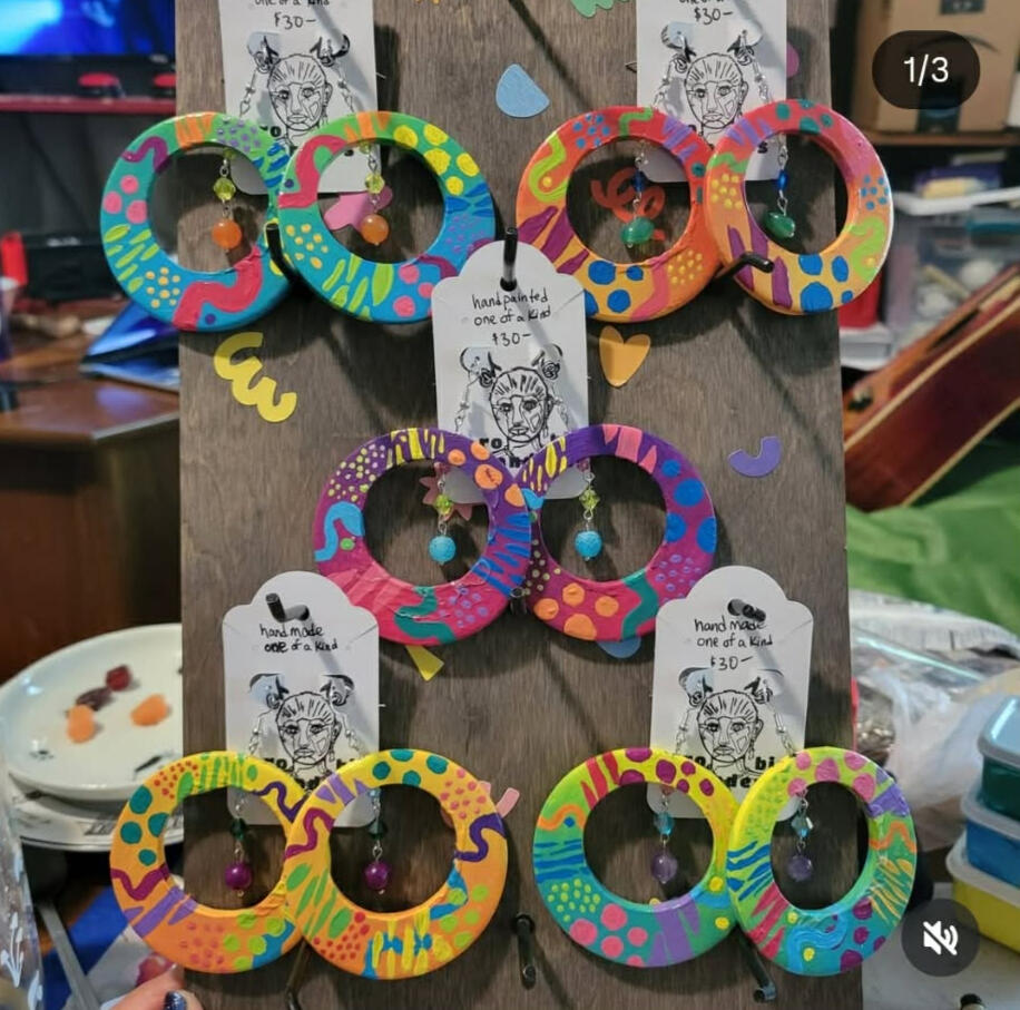 a picture of someone's wrist, wearing 4 colorful bracelets