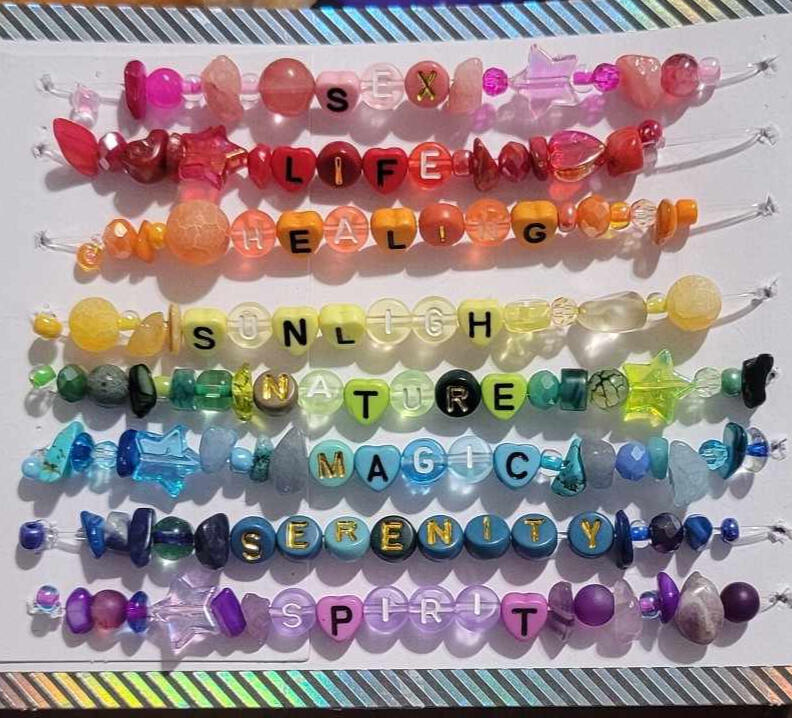 a picture of rainbow bead work, emulating Gilbert Baker's original pride flag